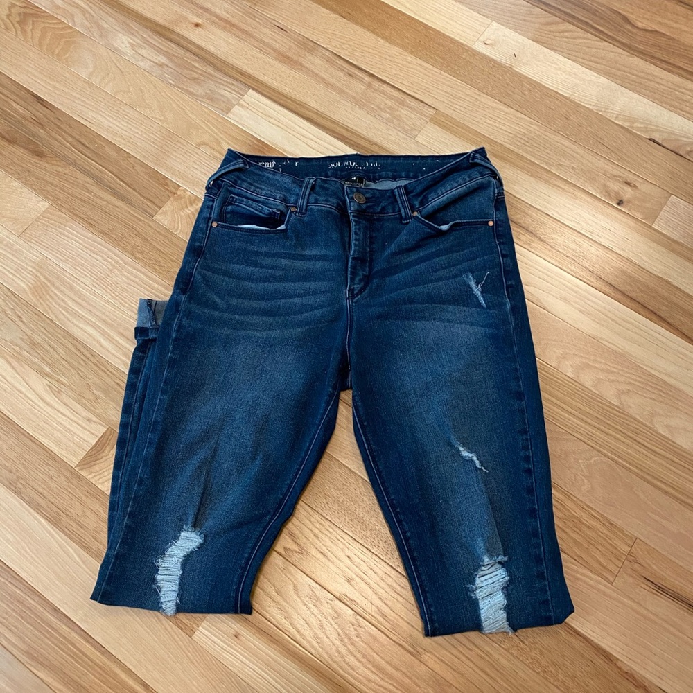 Dark jeans with factory distressing